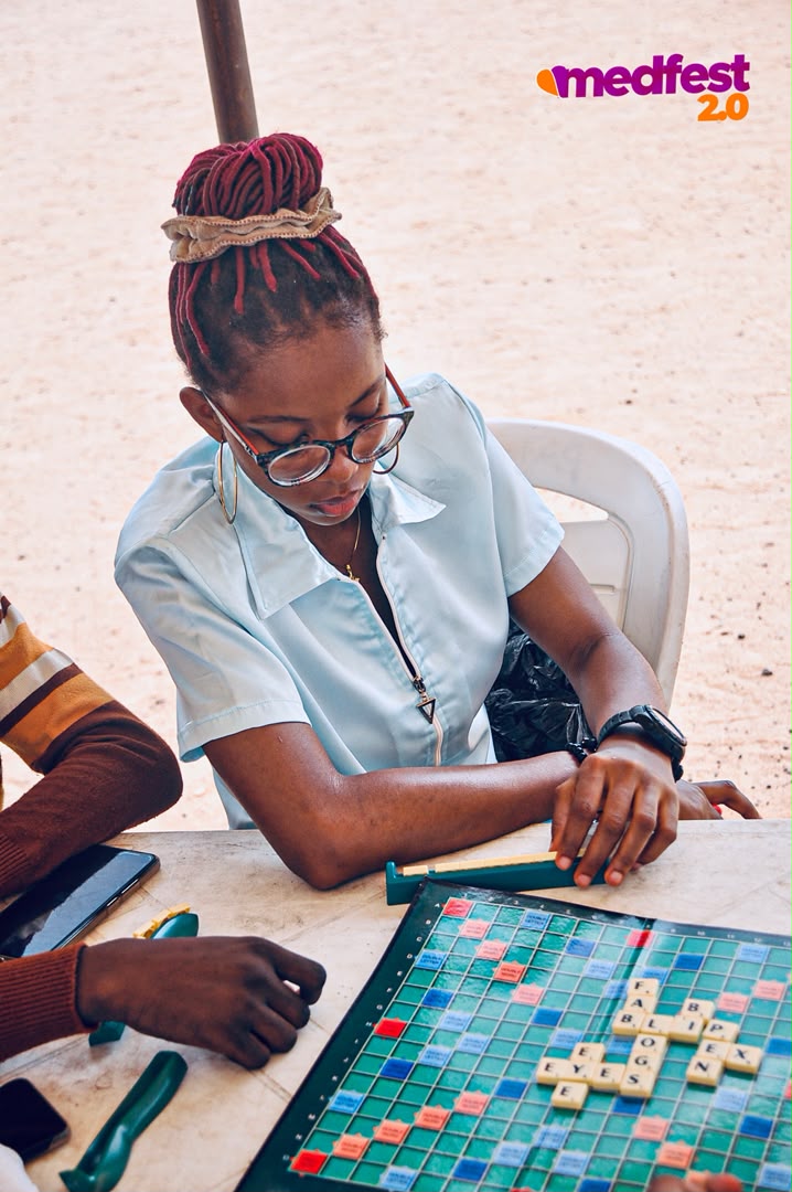 A guest playing a board game at MedFest 2.0